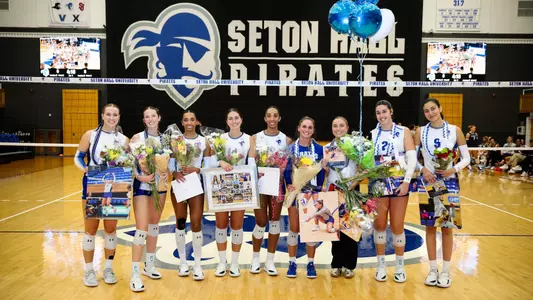 Those being celebrated during volleyball Senior Night on Nov. 23 pose for a group shot.