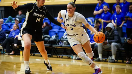 Faith Masonius drives against a Bryant defender on Nov. 16