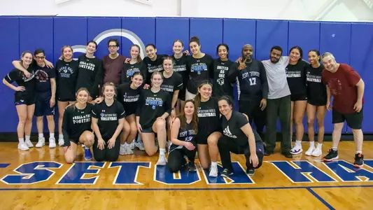 A large photo with the Seton Hall volleyball team and clients from JESPY House