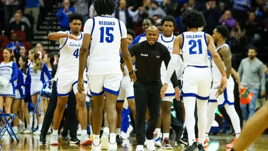 Shaheen Holloway celebrates with his team at a timeout against Xavier