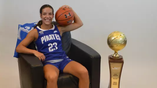 Baylor Franz poses next to Seton Hall's WNIT runner up trophy during her official visit as a recruit.