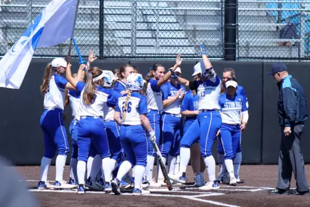 Softball Team Celebrating after Olivia Gilbert Home Run