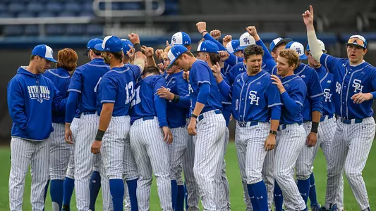 The baseball teams huddles up before a game against NJIT