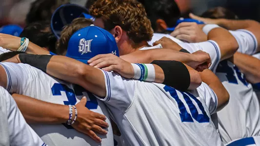 The Seton Hall baseball team huddles up before a game against St. John's