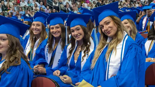 Student-athletes in the 2024 graduating class pose for a photo at the Prudential Center