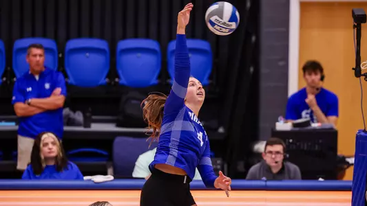 Reagan Merk spikes the ball against Kent State on Sept 8