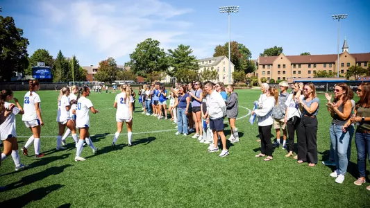 Seton Hall women's soccer alumnae greets the current Piirates team pregame against Villanova