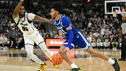 Jan 11, 2025; Providence, Rhode Island, USA; Seton Hall Pirates guard Isaiah Coleman (21) dribbles the ball against Providence Friars forward Oswin Erhunmwunse (55) during the second half at Amica Mutual Pavilion. Mandatory Credit: Eric Canha-Imagn Images