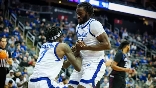 Prince Aligbe helps up Scotty Middleton against DePaul