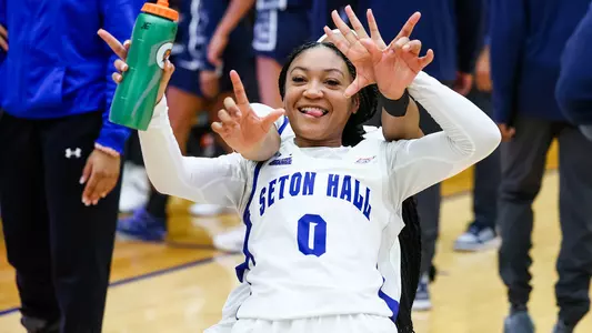 Jada Eads celebrates after a victory in Walsh Gym.