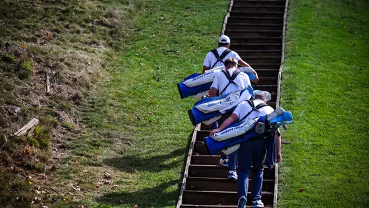 Members of the Seton Hall men's golf team climb the stairs during a practice round in the fall of 2024.