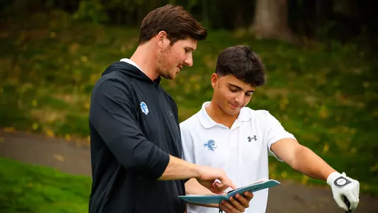 JT Harper and Eli Shah talk during a round in the fall of 2024.