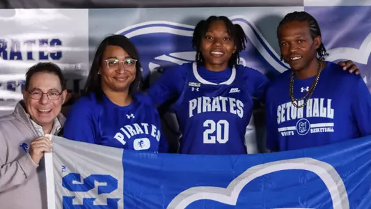 Trishay Collins poses with Tony Bozzella and her family during a recruiting visit