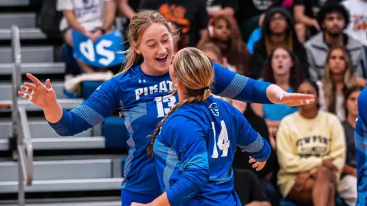 Maddy Loiselle and Emilee Fuller celebrate after a point against Saint Peter's on Sept. 10.