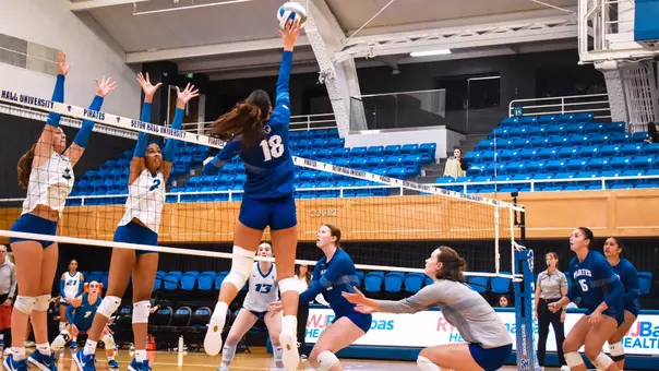 Sadie Reich attempts to spike the ball past a wall of CCSU defenders during a match on Sept. 7.