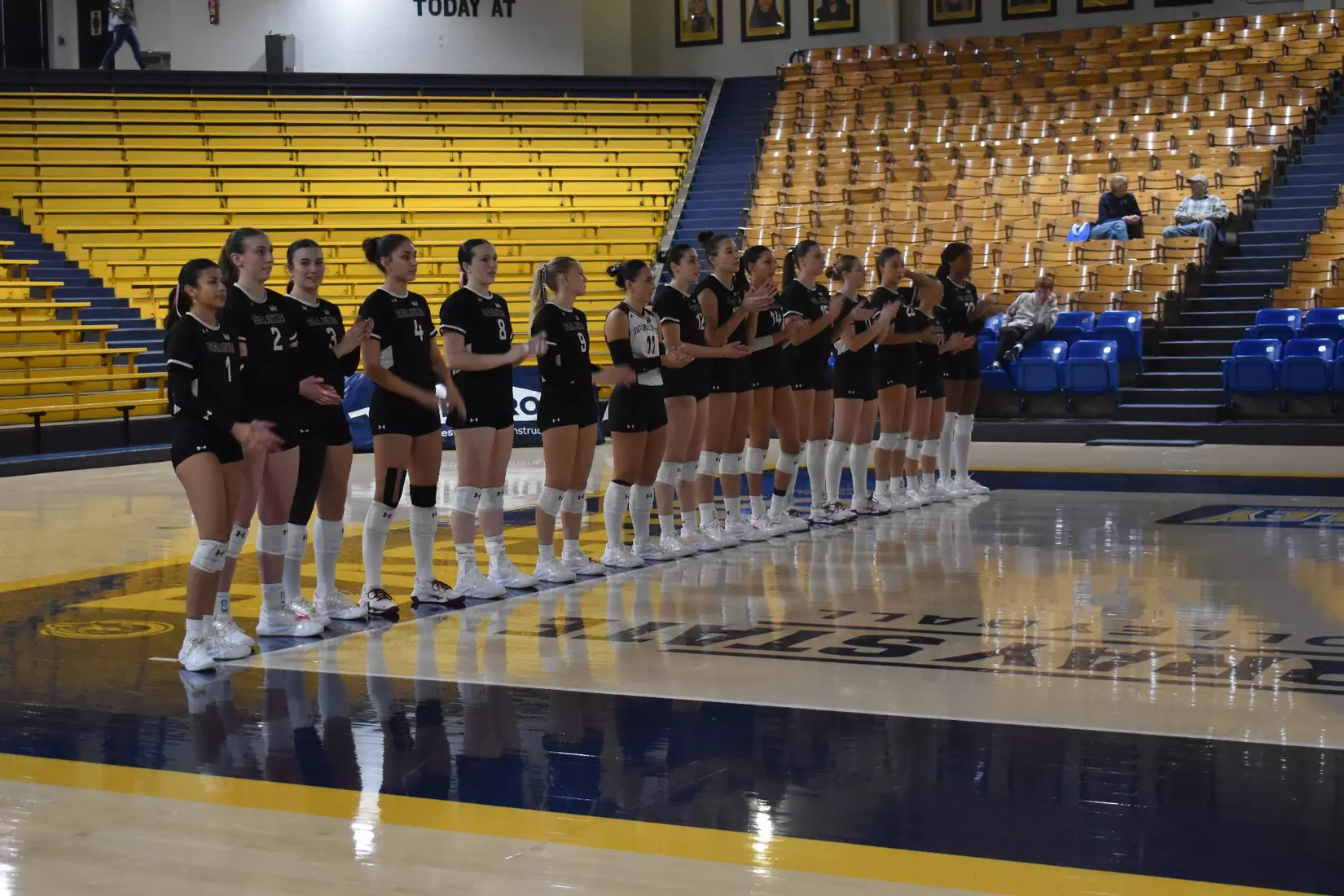 The team claps for opposing introductions.
