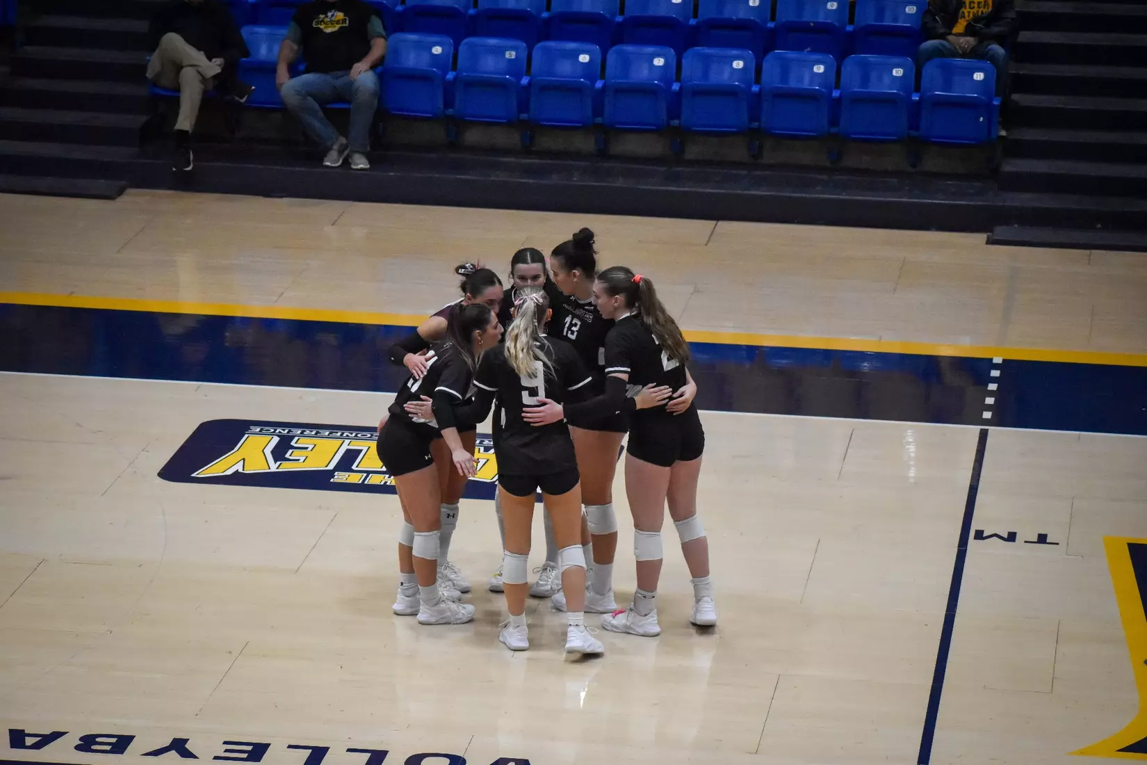 The team huddles after a point.