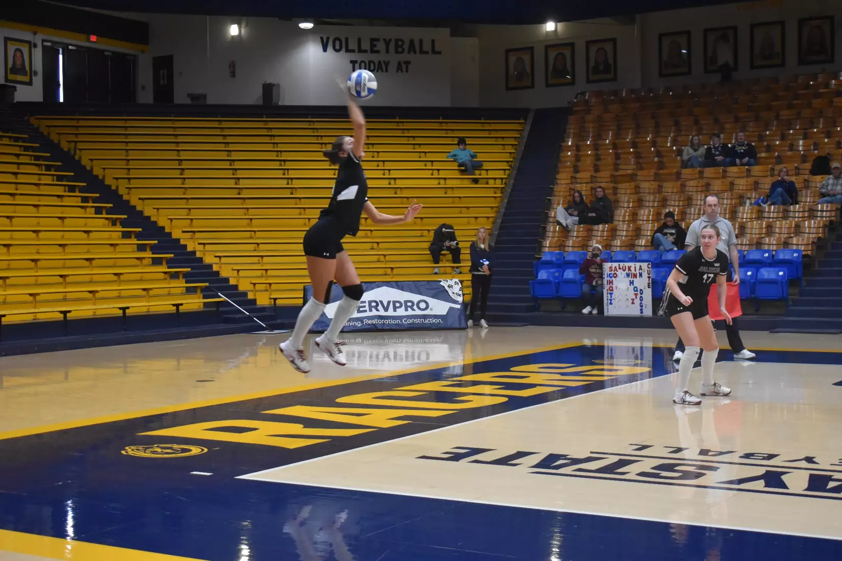 Ella McFarland serves a ball.