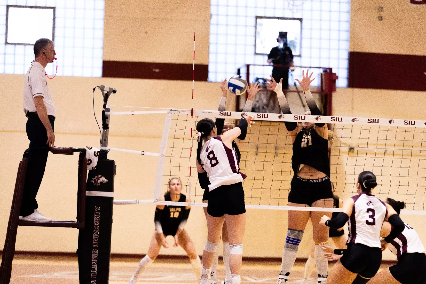 Alexandria Arrington attacks a ball in the match.