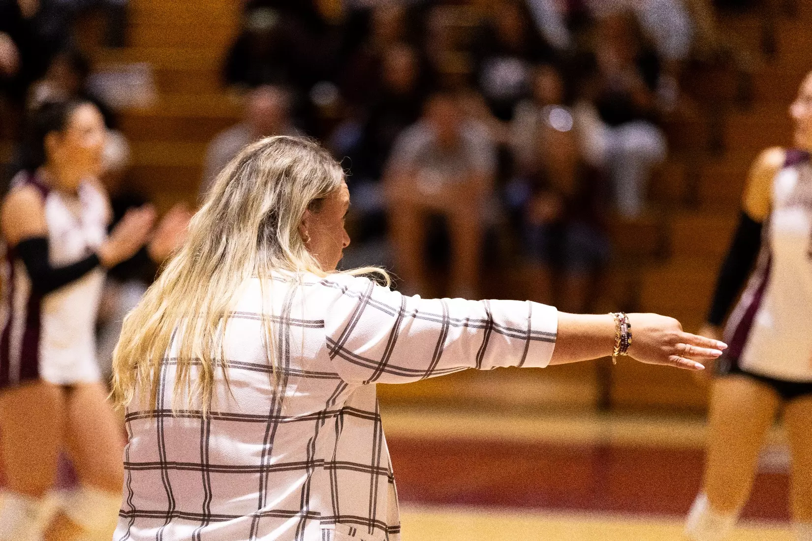 Head Coach Brittany Harry points to her team in direction.