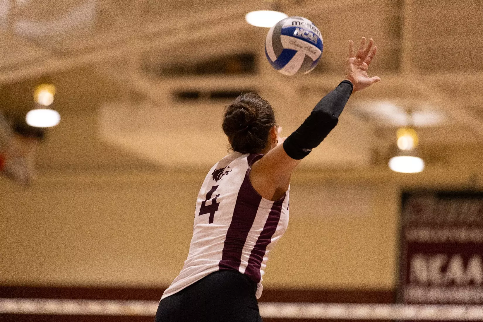 Ella McFarland serves a ball in the match.
