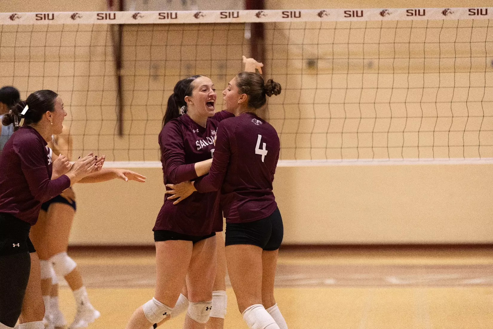 Alexandria Arrington and Ella McFarland do a chest bump.