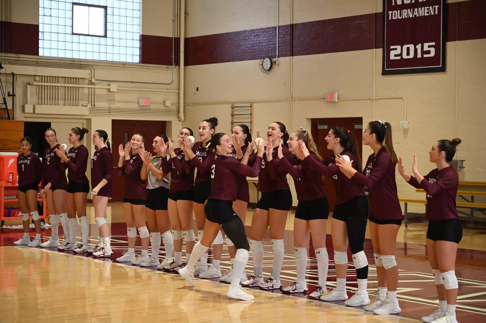 McKenzie Moeller high fives her teammates as her name is announced.