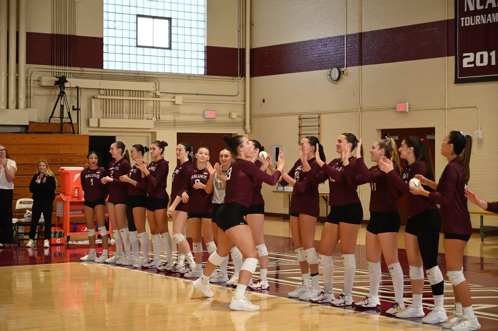 Beatriz Piaia high fives her teammates as her name is announced.