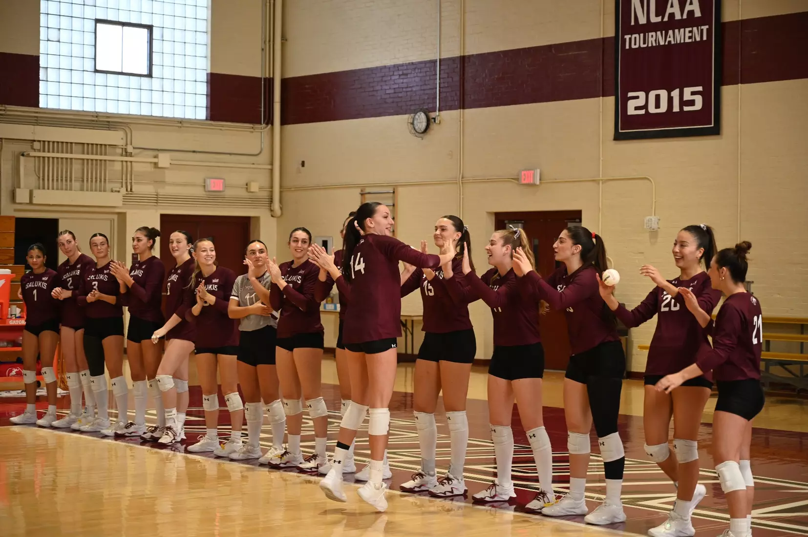 Ella Swansiger high fives her teammates as her name is announced.