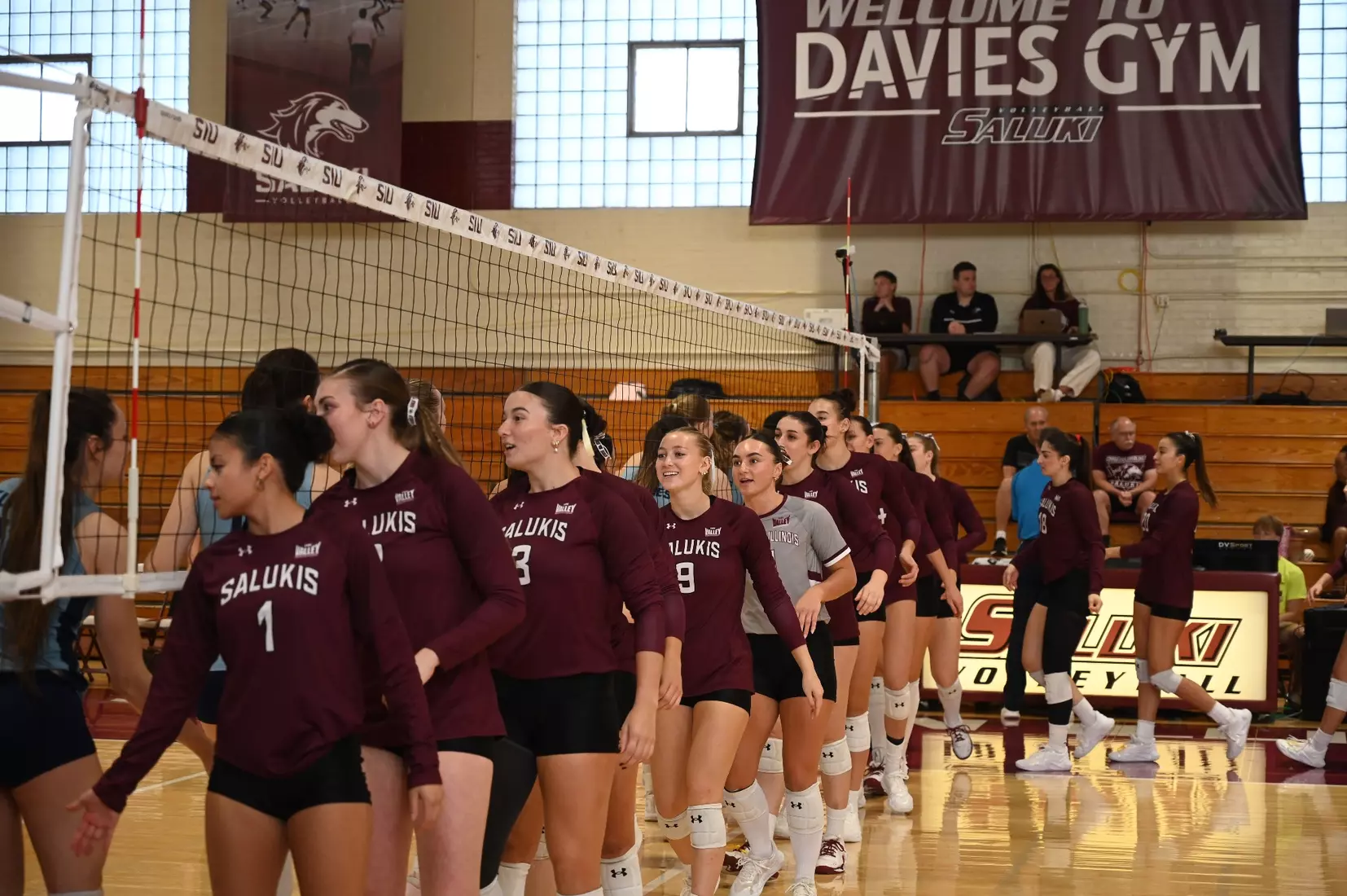 The team high fives the opponent prior to the match.