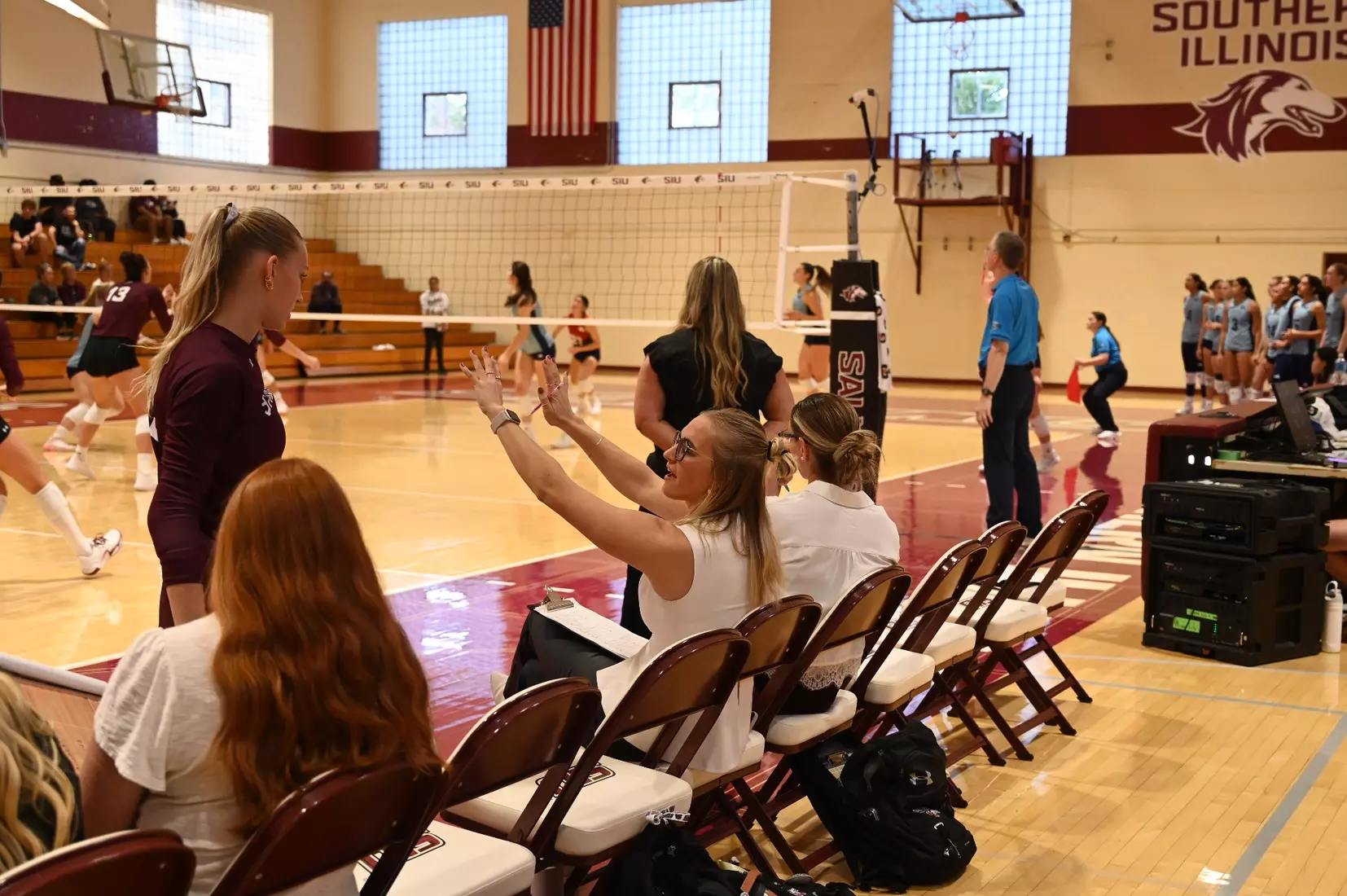 Graduate Assistant Emma Lade gives instruction to freshman Lillian Dempkey.