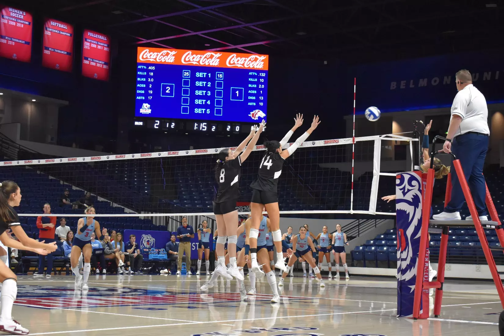 Alexandria Arrington and Ella Swansiger attack a ball.