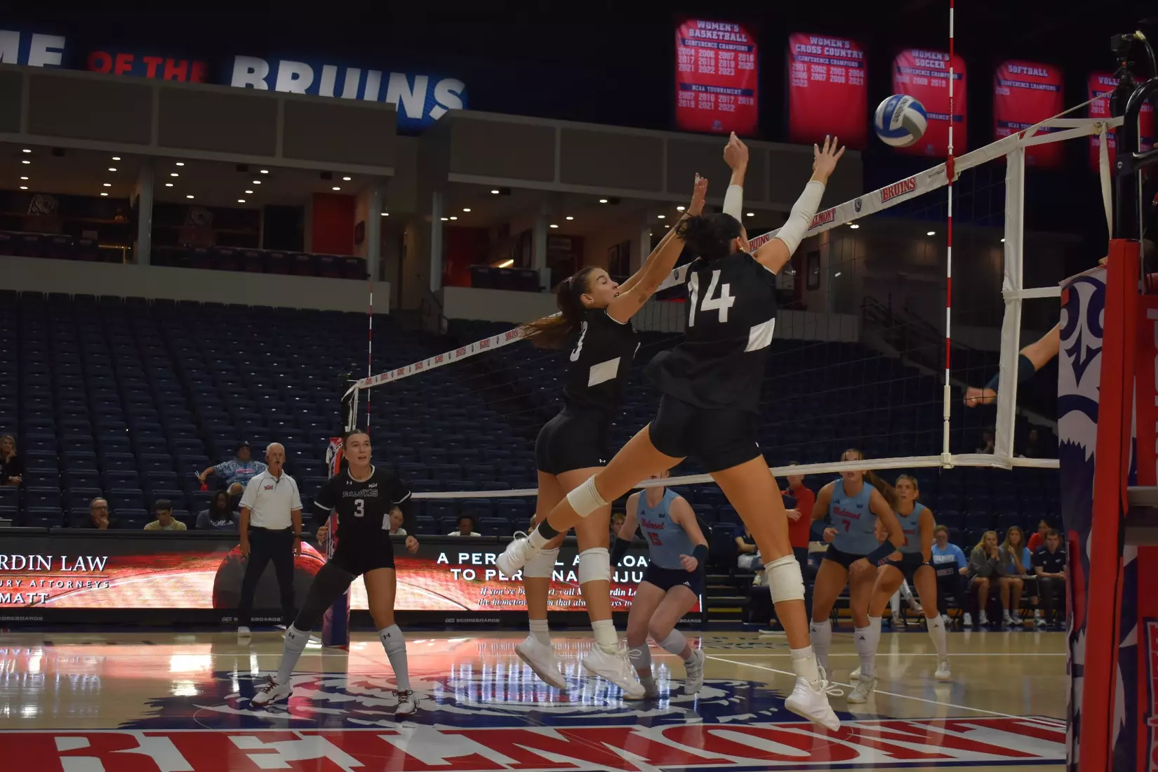 Beatriz Piaia and Ella Swansiger block a ball.