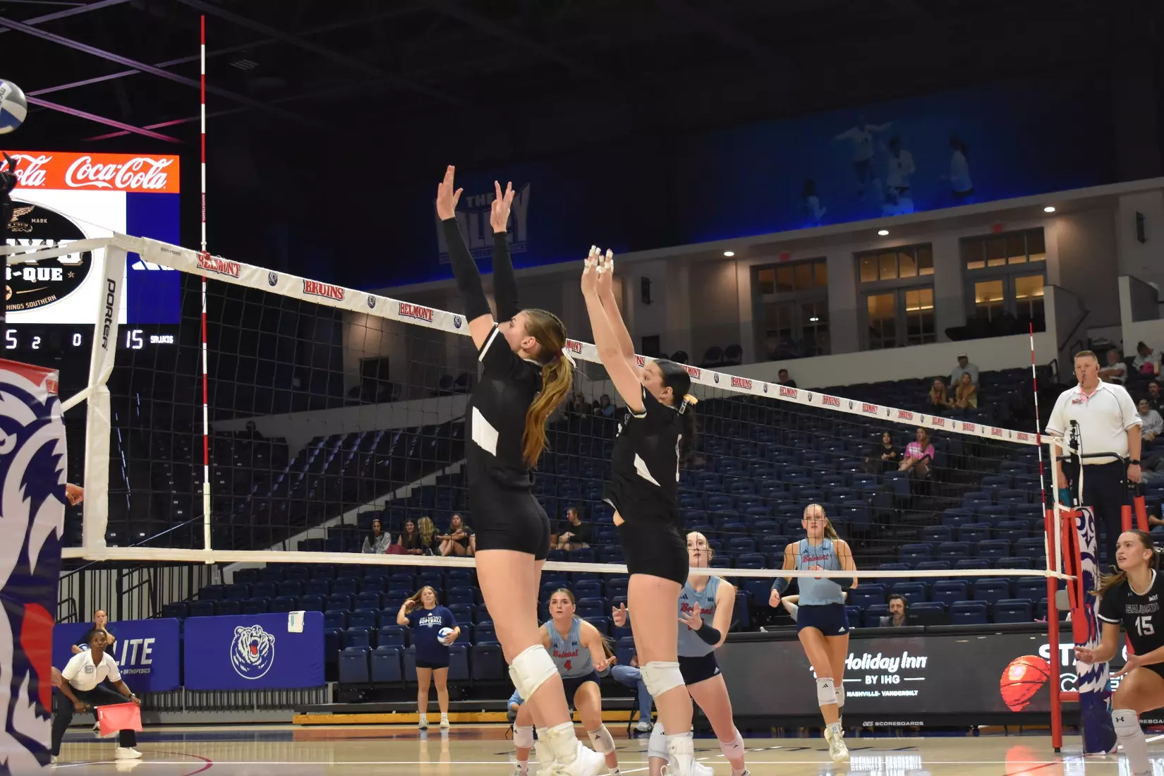 Natalie Vance and Alexandria Arrington go up to block a ball.