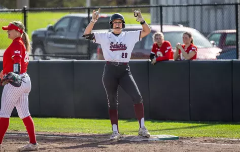 Sage Grann celebrates at first base during SIU's 7-2 win in Game 1 at Charlotte West Stadium.