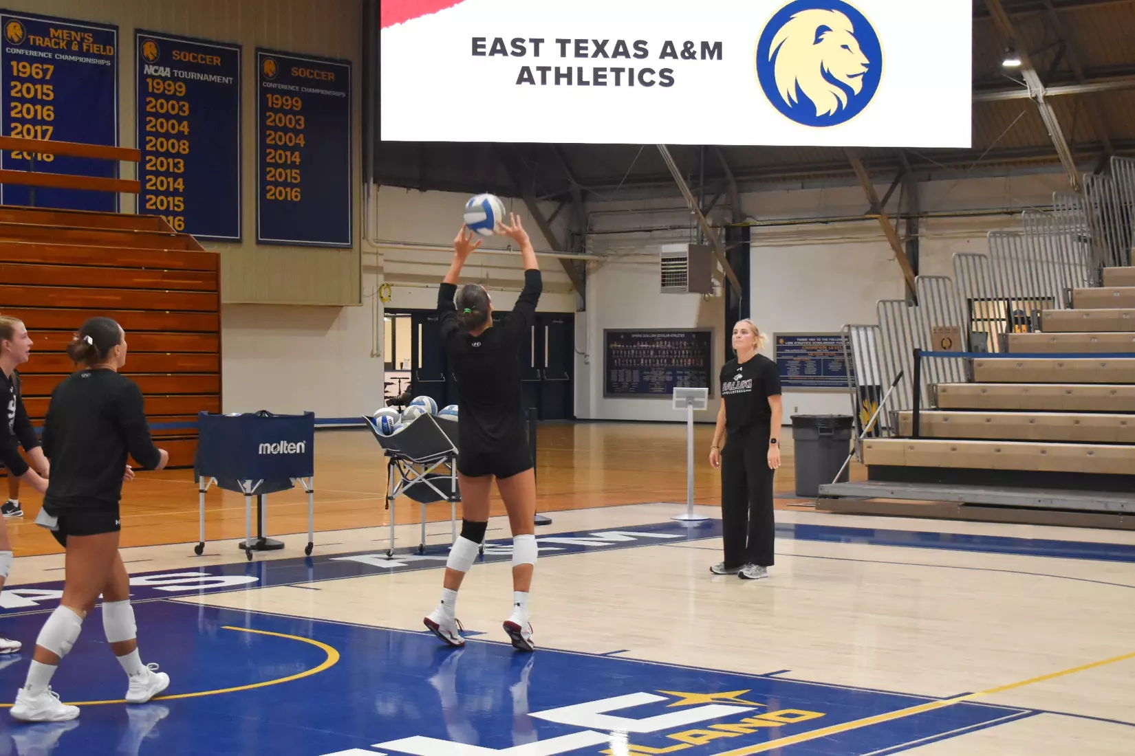 Ella McFarland sets a ball in warmups.