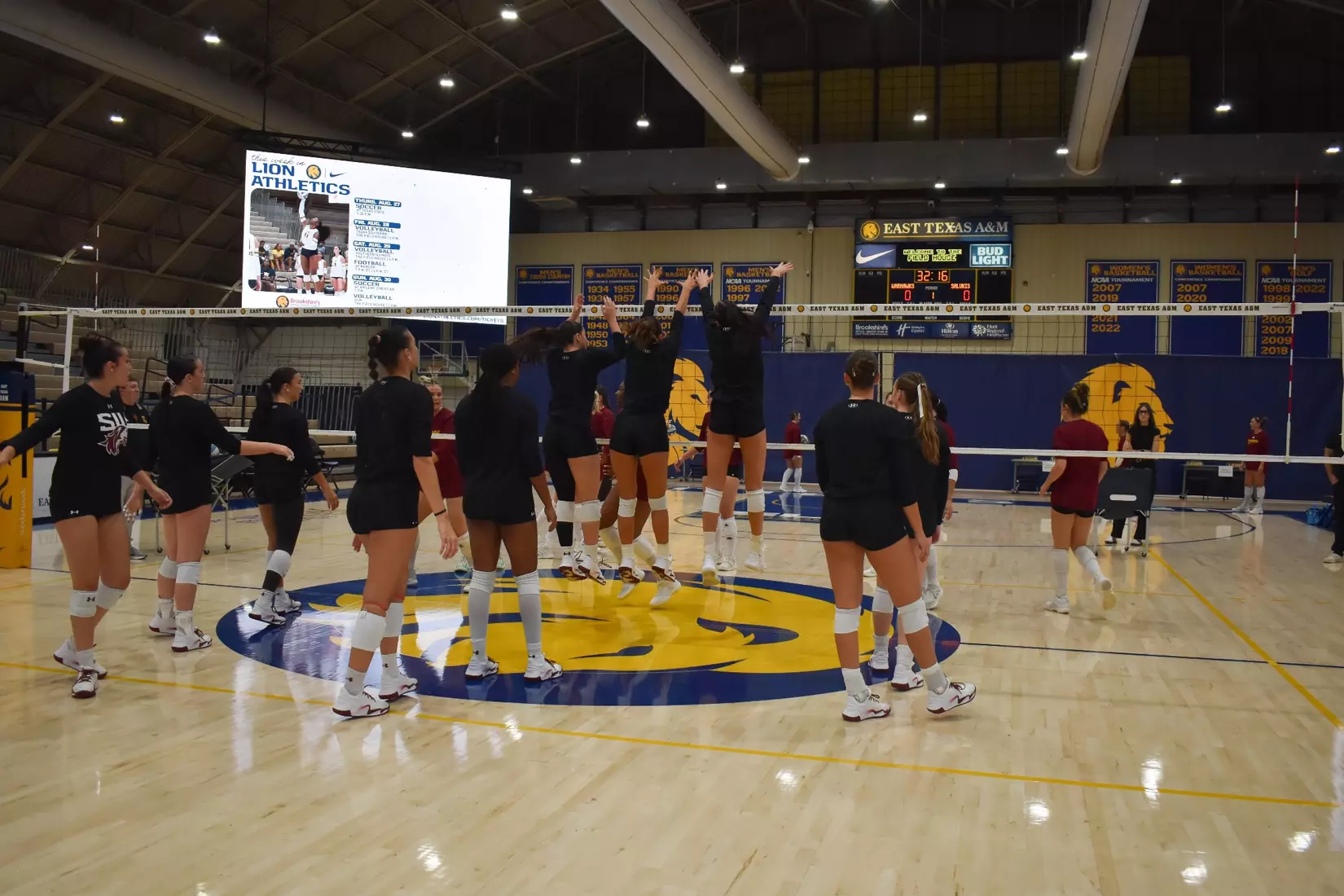 The team practices blocking in warmups.