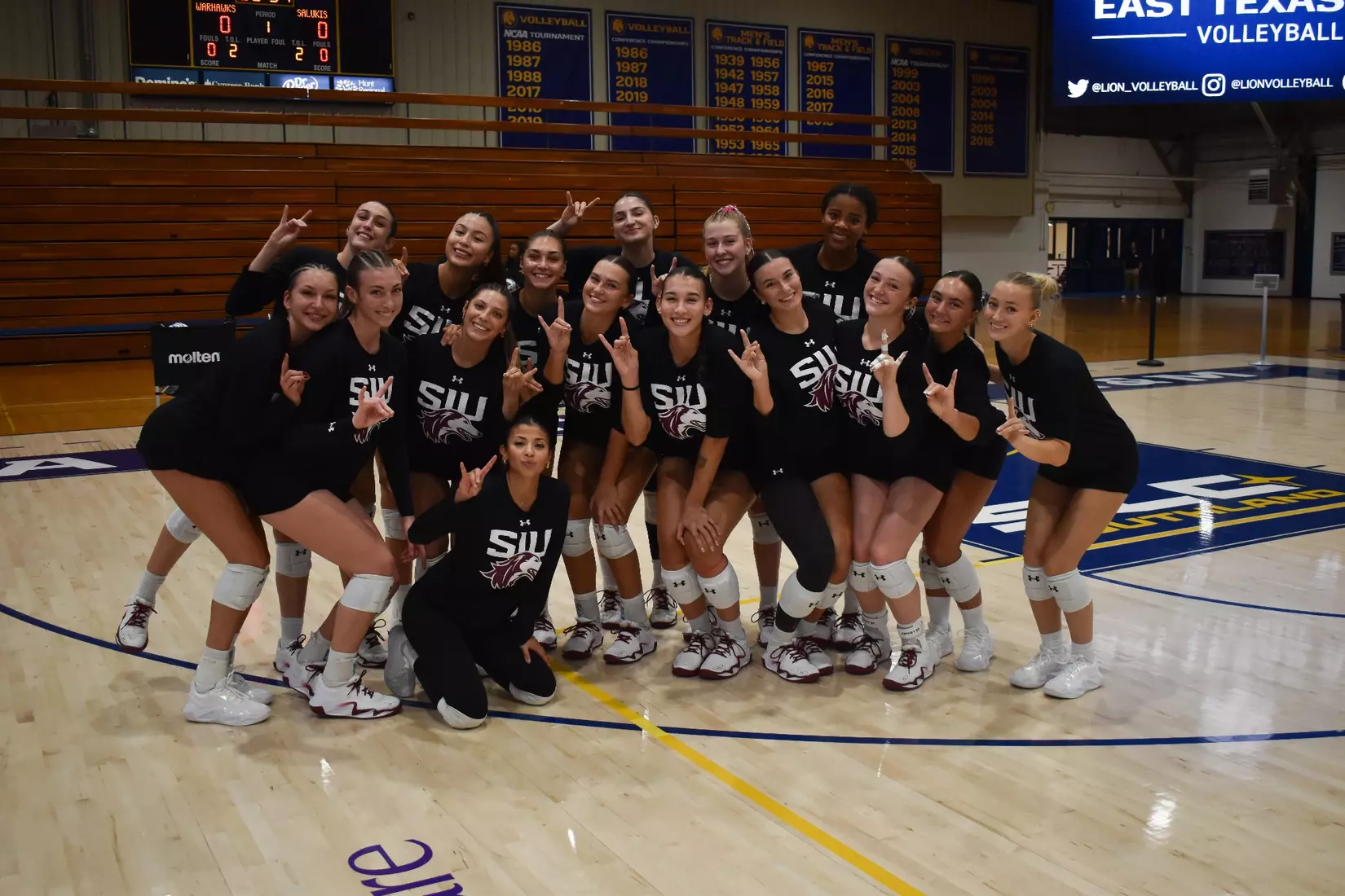 The team smiles for a picture pregame.