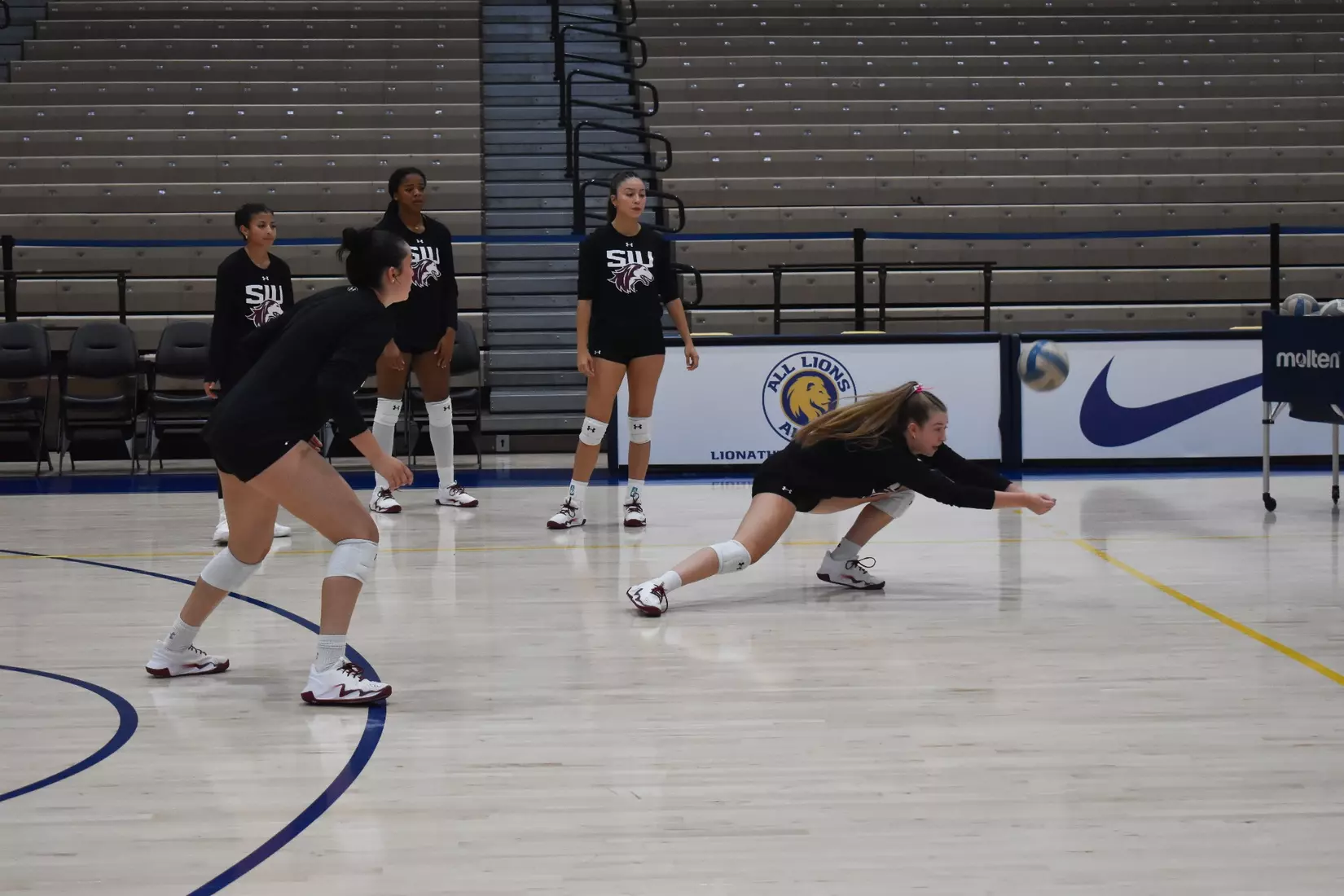 Julia Laidig dives for a ball in warmups.