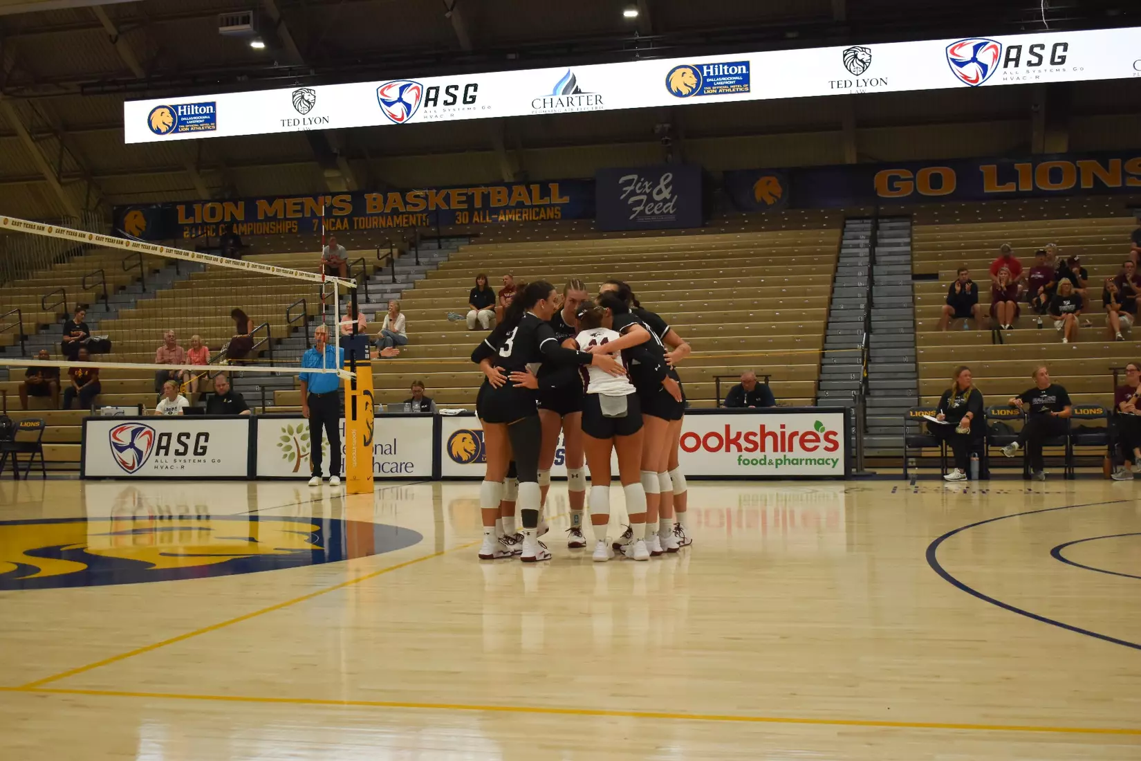 The team on the floor huddles prior to the start of the match.