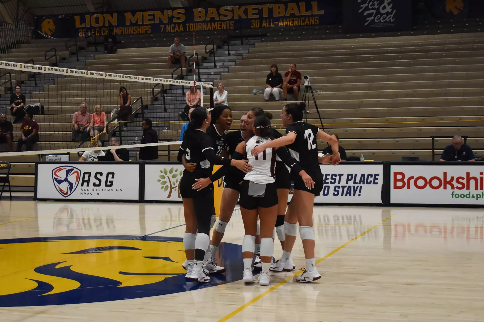 The team huddles after a point in celebration.