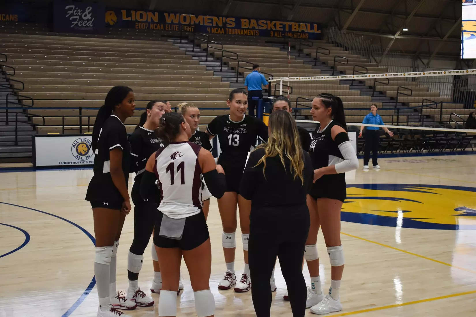Head Coach Brittany Harry talks to her team during a timeout.