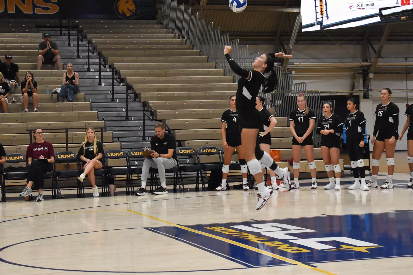 McKenzie Moeller jumps up for a serve.