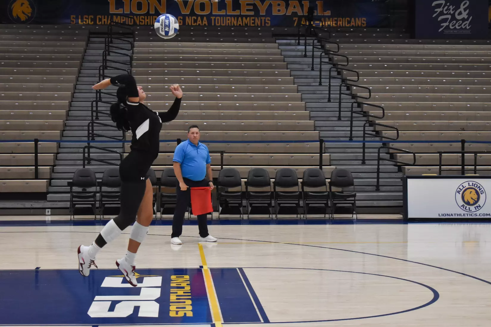 McKenzie Moeller jumps up to serve a ball in the match.
