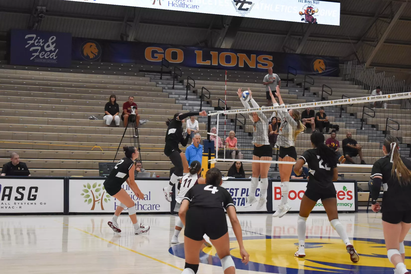 McKenzie Moeller smashes a ball through the arms of Warhawks blockers.