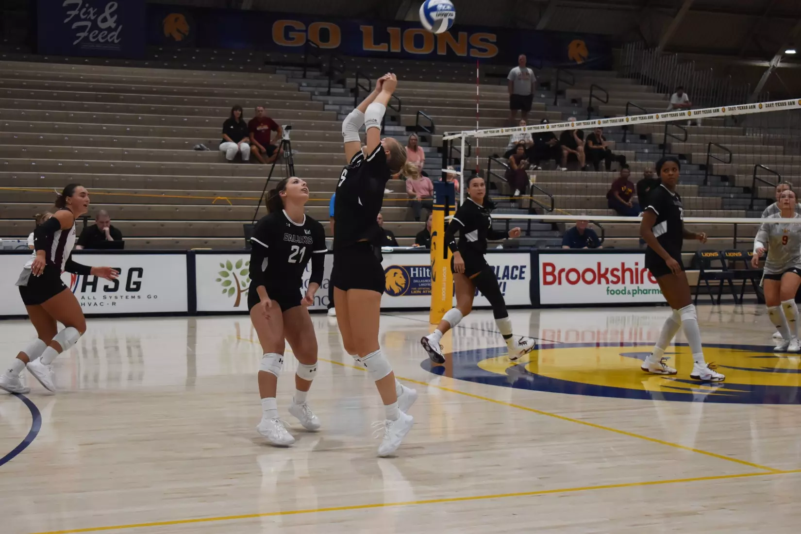 Lillian Dempkey bumps a ball backwards over her head.