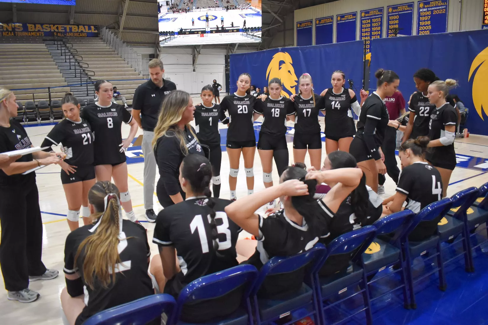 Head Coach Brittany Harry talks to her team during a timeout.