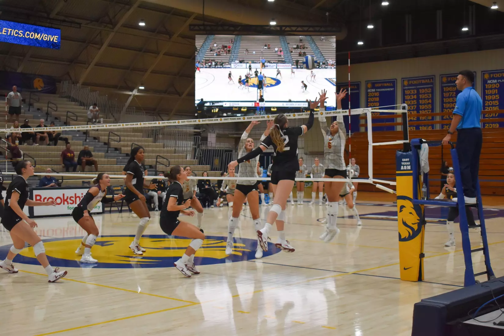 Natalie Vance tips a ball over the net.