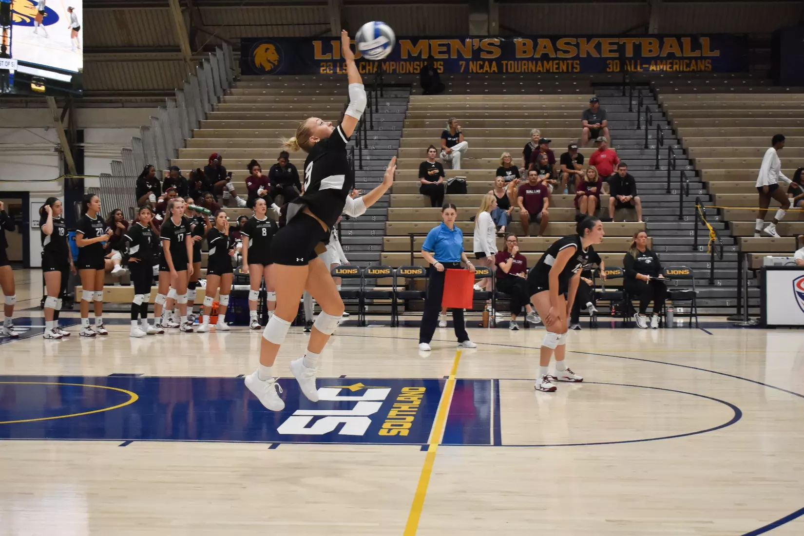 Lillian Dempkey serves a ball in the match.