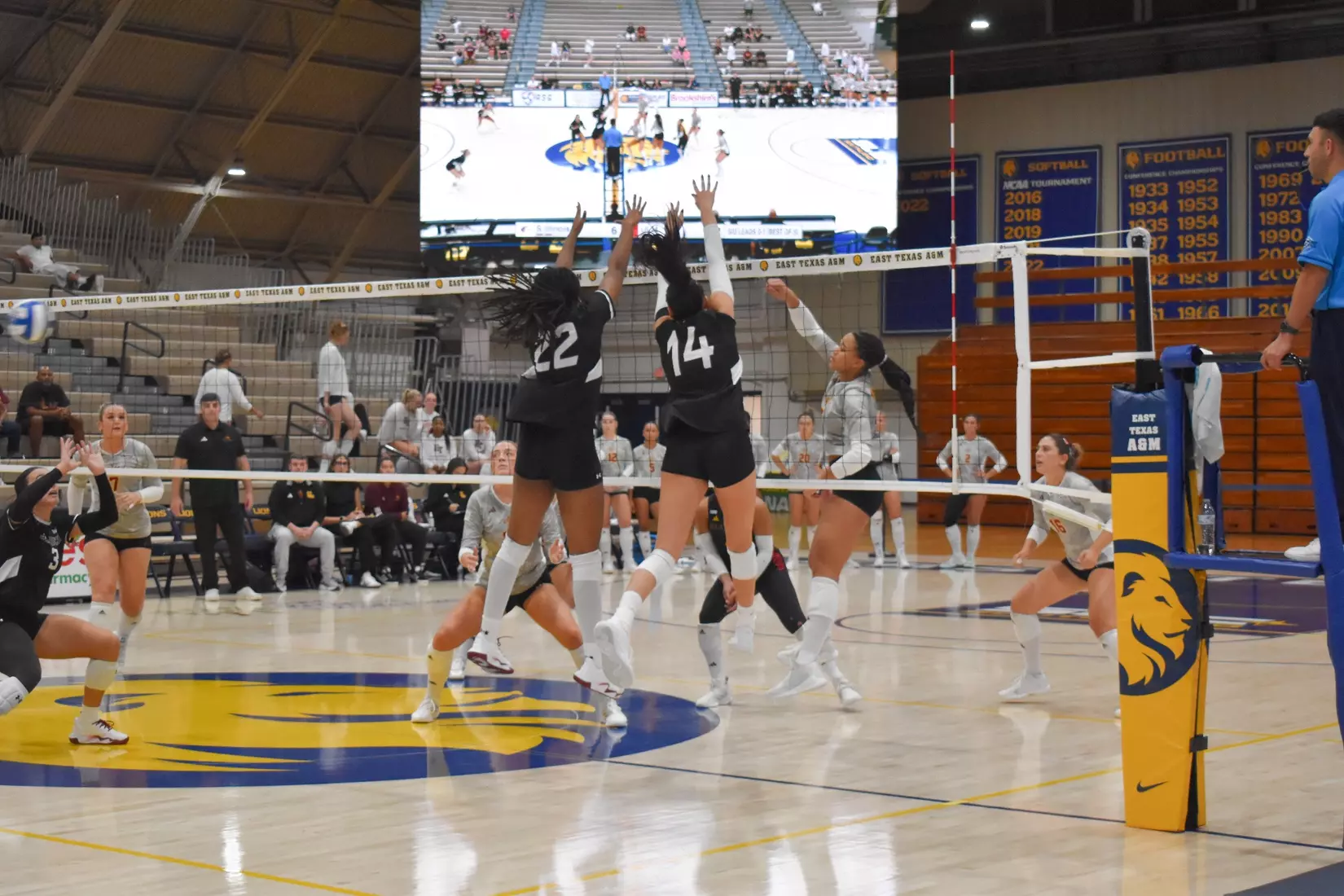 Chloe Anderson and Ella Swansiger jump to block a ball in the match.